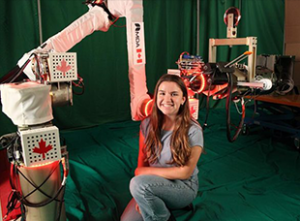 PEY Co-op student Erin Richardson standing next to autonomous robot