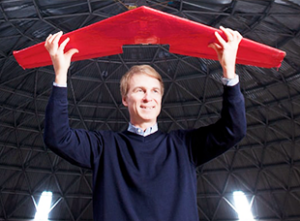 professor David Zingg holding a plane model