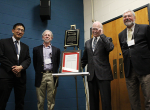 Chris Yip, David Ribner, Tom Siddon, and Christopher Damaren standing with the Ribner Award plaque