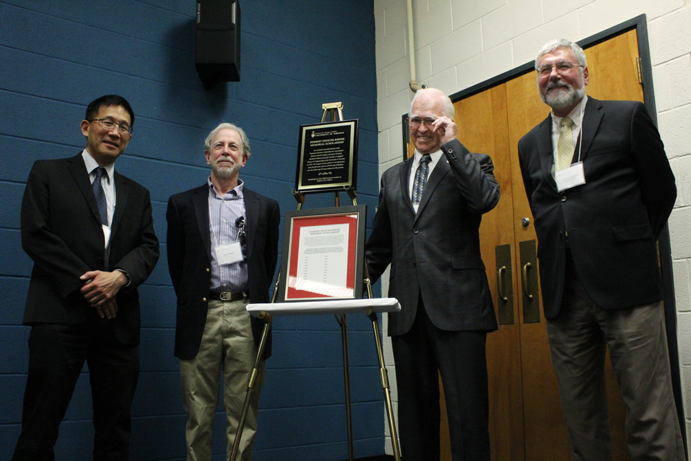 Chris Yip, David Ribner, Tom Siddon, and Christopher Damaren standing with the Ribner Award plaque