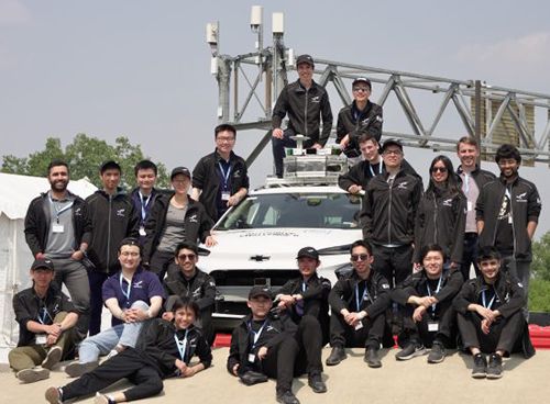 Team of students from aUToronto pose in front of autonomous vehicle