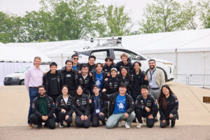 Students and professor Waslander gather in front of the autonomous vehicle